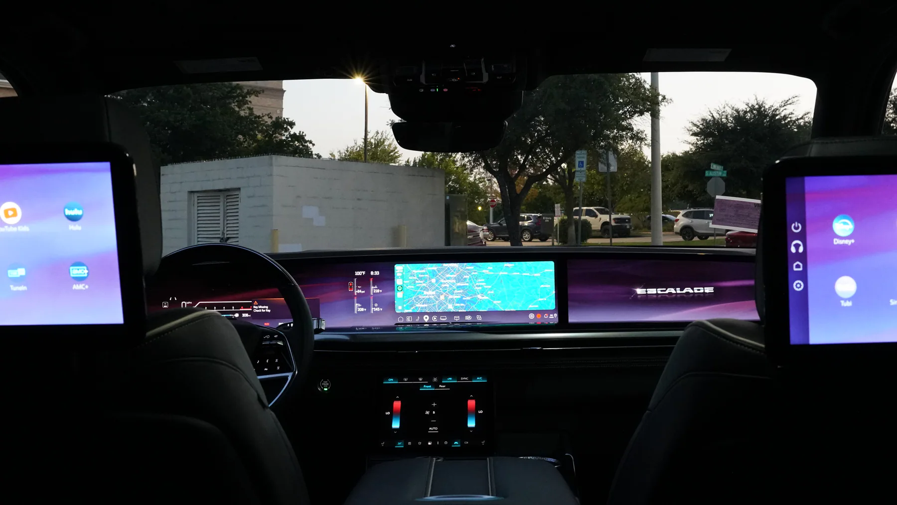 Cadillac Escalade cabin with rear entertainment screens and digital dashboard