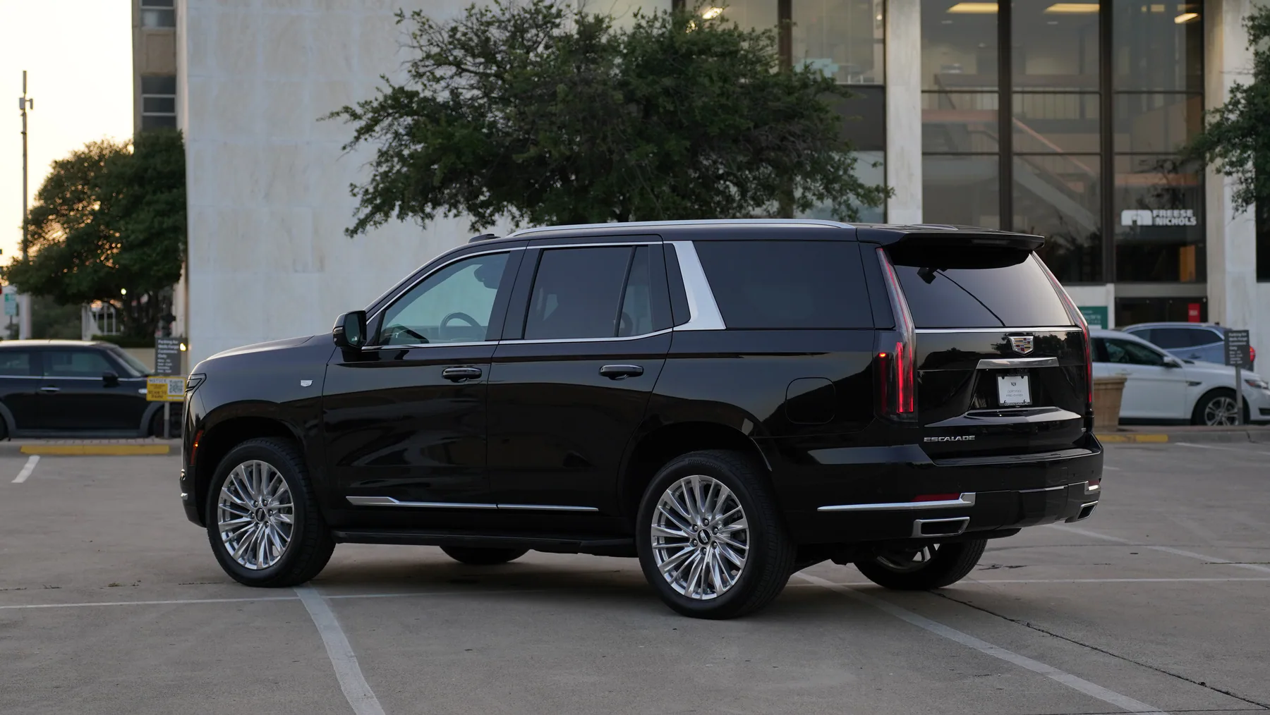 Rear three-quarter view of the black Cadillac Escalade