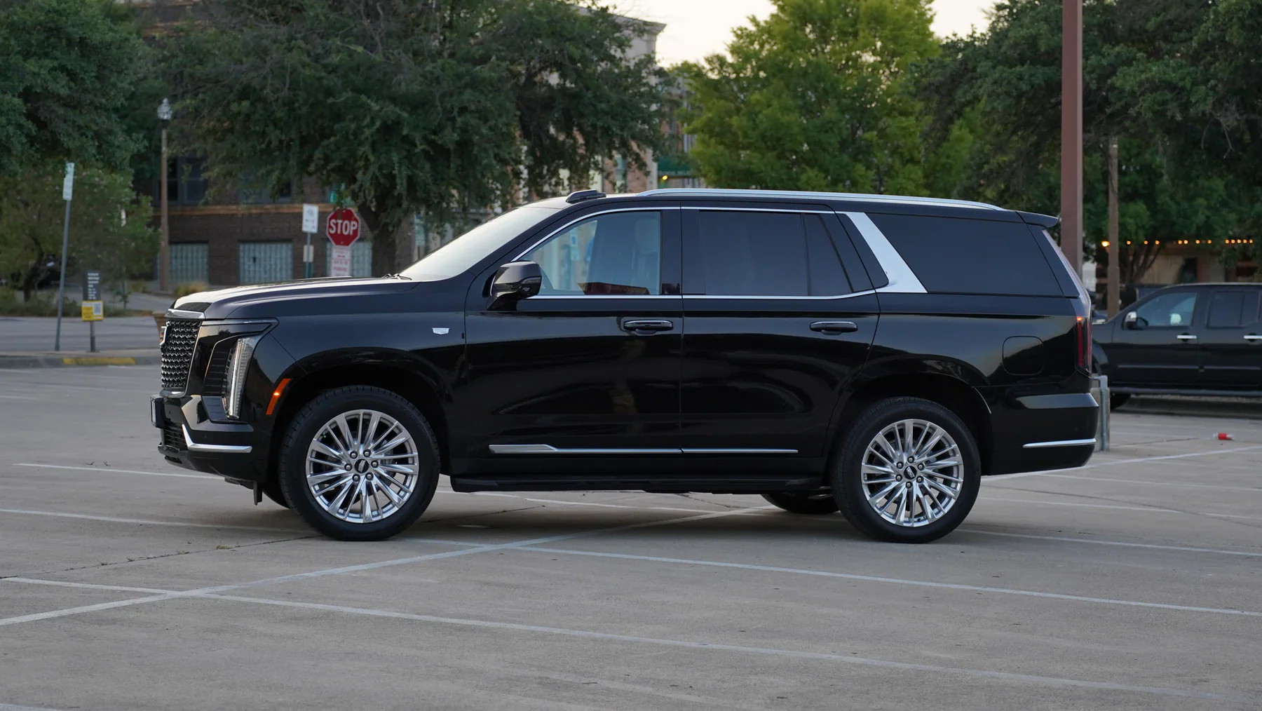 Side profile of the black Cadillac Escalade luxury SUV