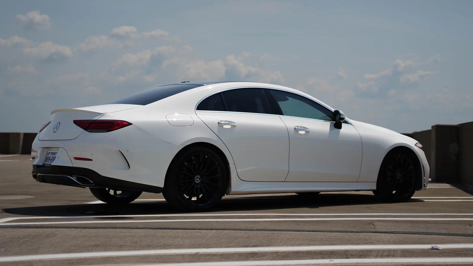 Rear side profile of the white Mercedes CLS 450