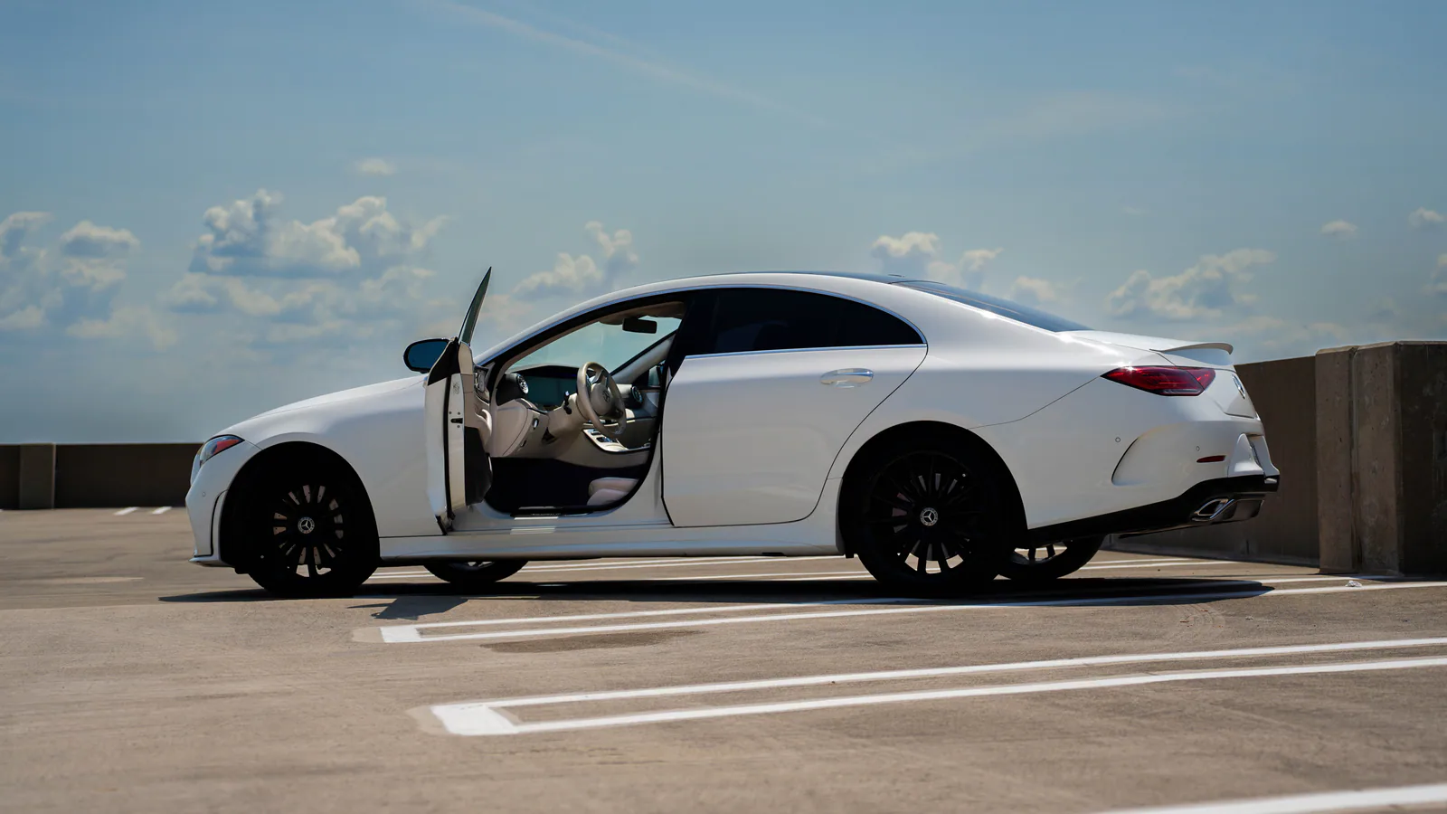White Mercedes CLS 450 with the driver door open in Dallas