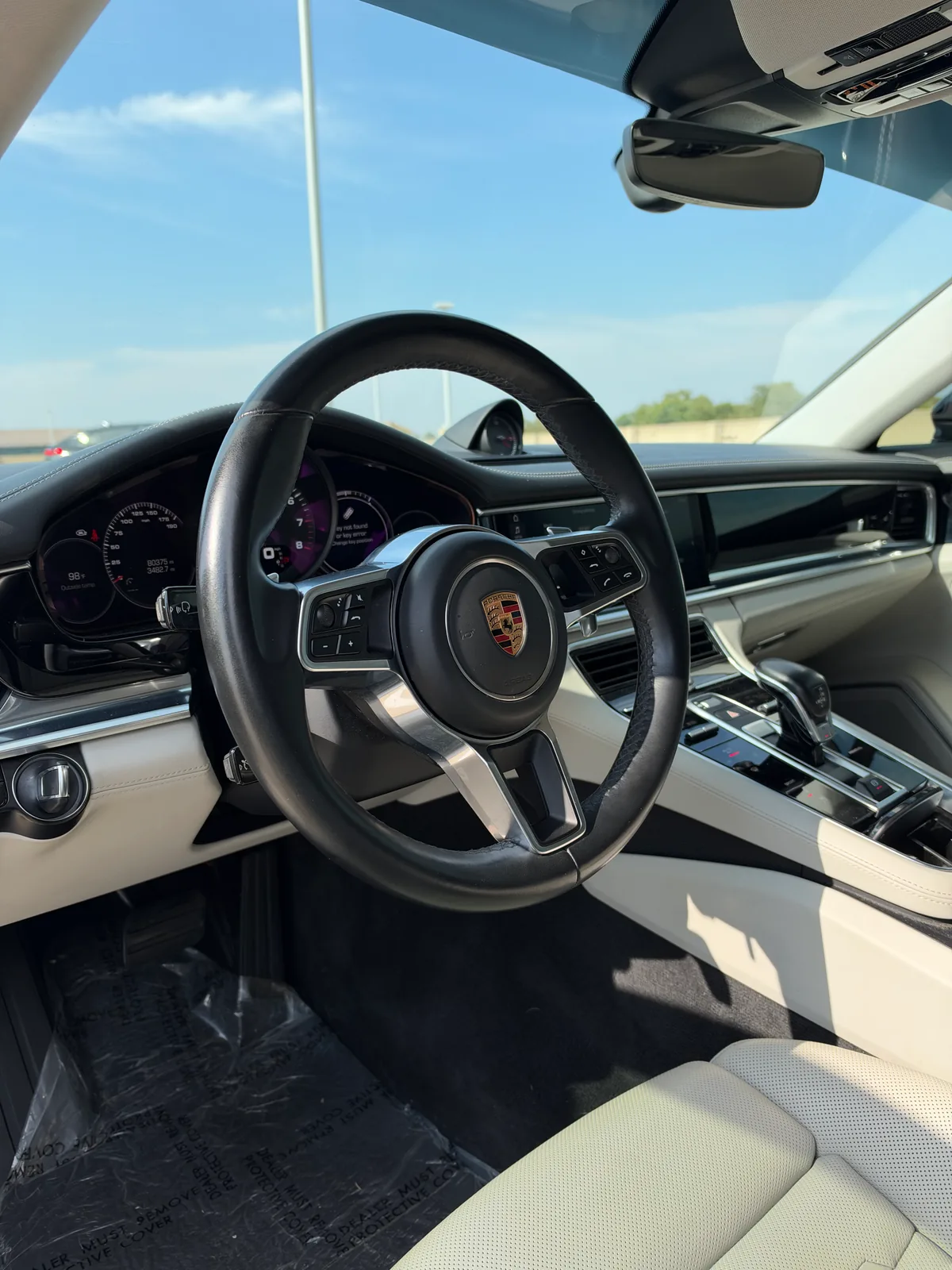 Porsche Panamera driver cockpit with cream interior and central touchscreen
