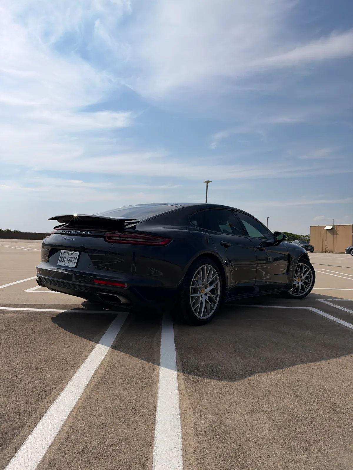 Rear passenger-side angle of the blue Porsche Panamera