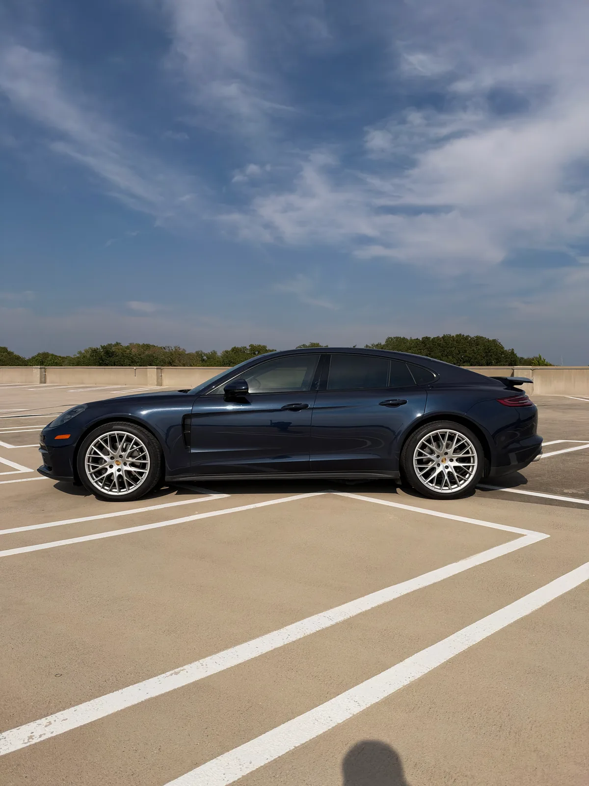 Side profile of the blue Porsche Panamera with silver multi-spoke wheels