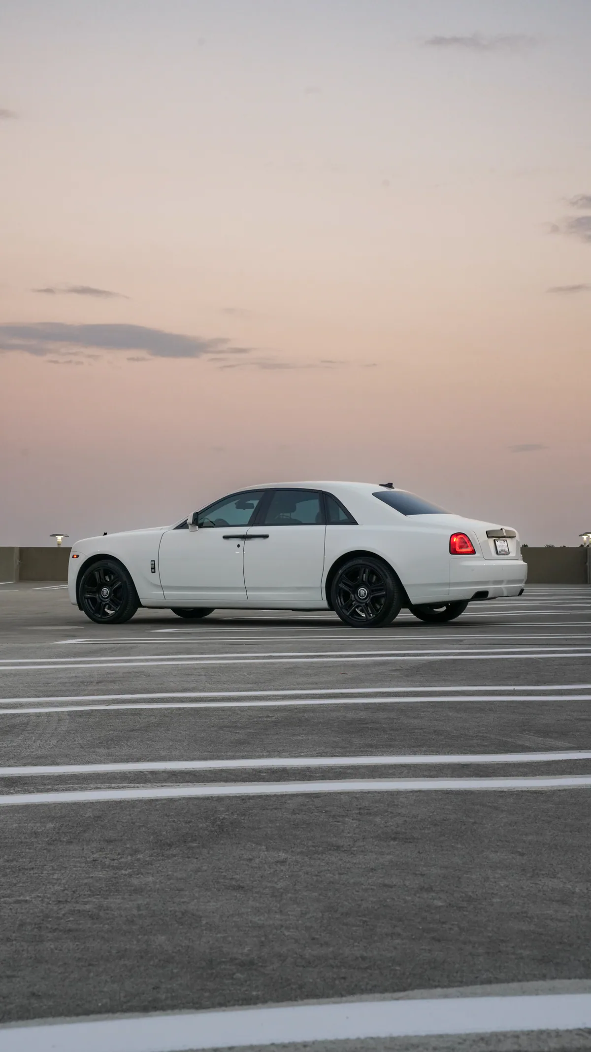 Side profile of the white Rolls-Royce Ghost luxury rental in Dallas